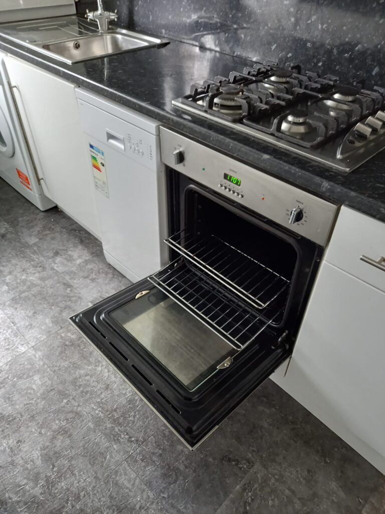 oven cleaning services London professional cleaner removing grease and deep cleaning oven interior